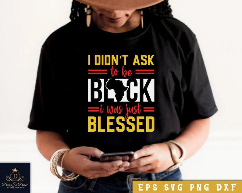 May include: Black t-shirt with a graphic design that says "I didn't ask to be black, I was just blessed". The graphic includes a red outline of the continent of Africa.
