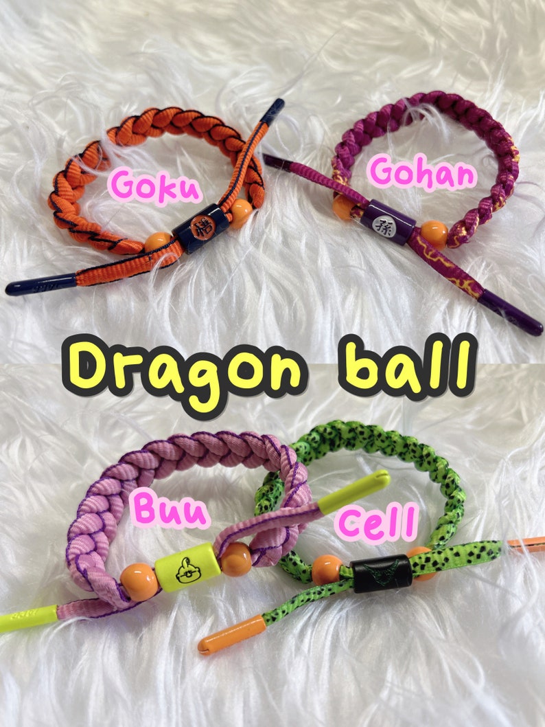 May include: Four colorful woven bracelets with different characters from the Dragon Ball anime series. The bracelets are orange, purple, pink, and green with yellow beads and black accents. The characters are Goku, Gohan, Buu, and Cell.