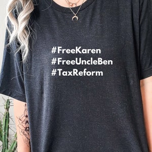 May include: Black t-shirt with white text that reads "#FreeKaren #FreeUncleBen #TaxReform".