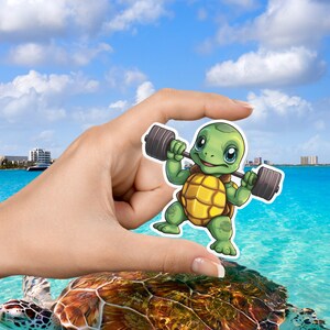 May include: A cartoon illustration of a green turtle lifting a barbell. The turtle is smiling and has a yellow shell. The background is a blue ocean with a beach.