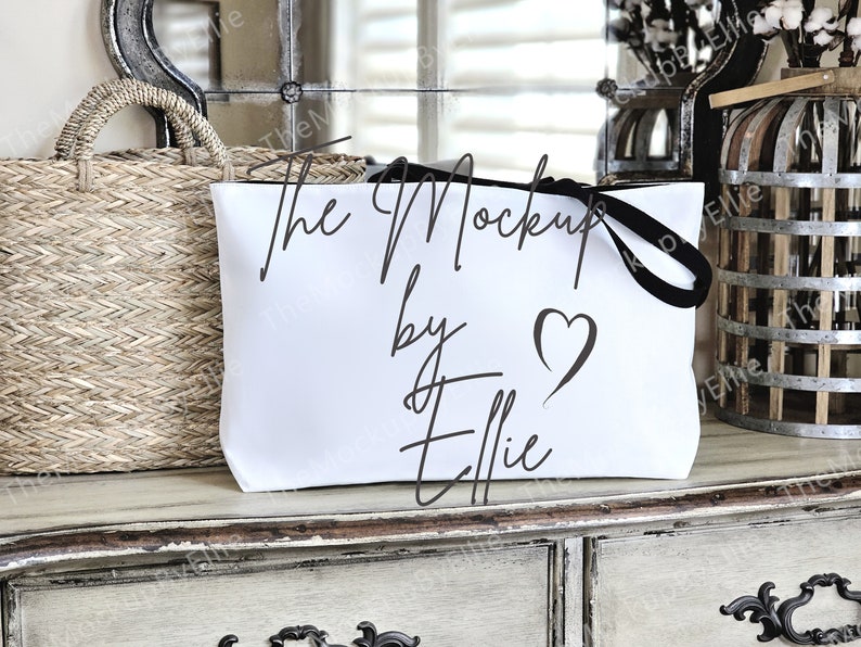 May include: White zippered pouch with a black zipper pull and the text "The Mockup by Ellie" in black script with a heart.