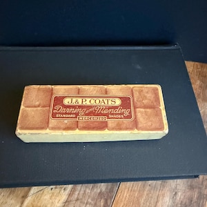 May include: A vintage J. & P. Coats darning and mending kit. The rectangular box is light green with a red and white label. The label reads "J. & P. Coats Darning and Mending Standard Mercerized Shades."
