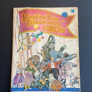 May include: A vintage program for the Ringling Bros. and Barnum & Bailey Circus, featuring a colorful illustration of performers, animals, and a banner that reads "The Greatest Show on Earth". The program is from the 99th season and costs $1.00.