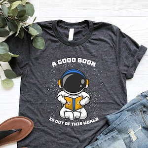A Good Book Is Out Of This World Shirt, Book Lover Shirt, Astronaut Reading Book Shirt, Space Lover Shirt, Bookworm Space Shirt, Bookish Tee