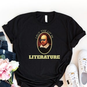 May include: Black t-shirt with a graphic of William Shakespeare wearing sunglasses and the text "I put the lit in literature".