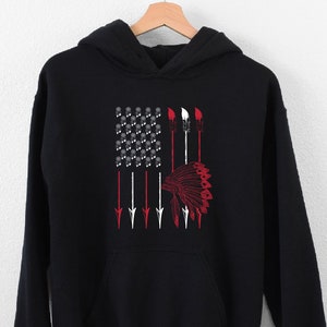 May include: Black hooded sweatshirt with a graphic of an American flag with arrows and a Native American headdress.