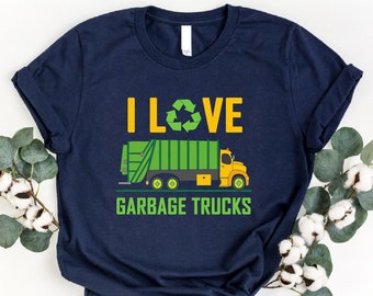 May include: A navy blue t-shirt with a green garbage truck and the text "I LOVE GARBAGE TRUCKS" printed on the front.