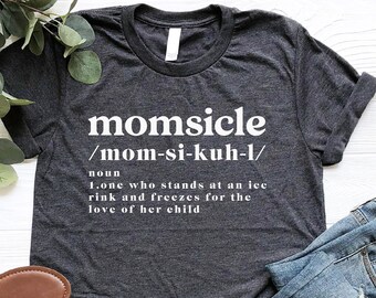 May include: A dark gray t-shirt with white text that reads "momsicle /mom-si-kuh-l/ noun 1.one who stands at an ice rink and freezes for the love of her child"