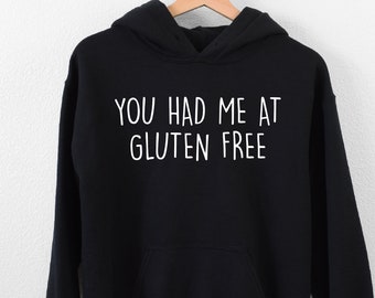 May include: Black hooded sweatshirt with the text "You had me at gluten free" in white.