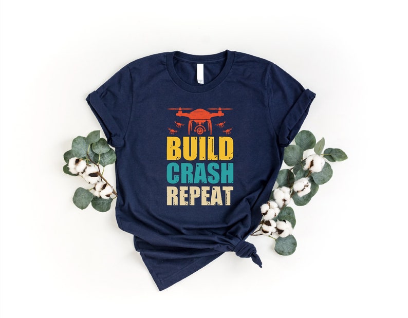 a t - shirt with the words build crash repeat on it