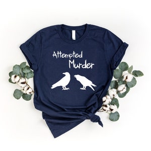 a t - shirt with two crows on it