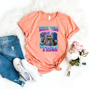 a t - shirt that says meow meow next to a pair of jeans