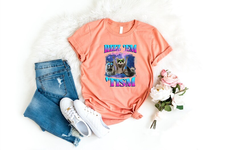 a t - shirt that says meow meow next to a pair of jeans