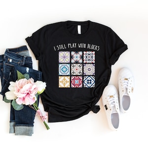 a t - shirt that says i still play with blocks