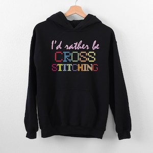 a black sweatshirt with the words i'd rather be cross stitching on it