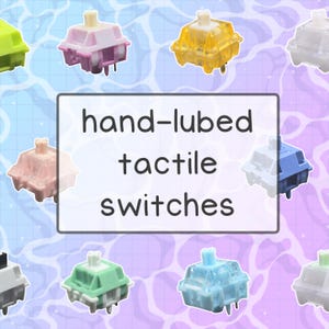 May include: An assortment of colorful hand-lubed tactile switches. The switches are in various colors, including pink, yellow, blue, and green. The text "hand-lubed tactile switches" is displayed in a white rectangle.
