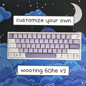 May include: A white and lavender mechanical keyboard with the text "customize your own" and "wooting 60he v2". The keyboard is set against a blue background with cloud and moon designs.