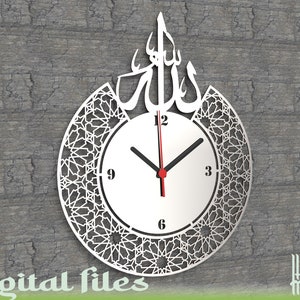 May include: A white clock with a silver Arabic calligraphy design of the word "Allah" above the clock face. The clock face has black hands and a red second hand. The clock is surrounded by a decorative, intricate geometric pattern.