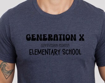 May include: A navy blue t-shirt with the text "GENERATION X ADULTING SINCE ELEMENTARY SCHOOL" in black.