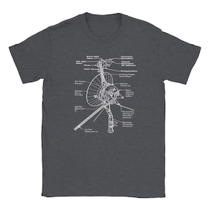 May include: A dark heather grey t-shirt with a white outline of the Voyager 1 spacecraft. The spacecraft is labeled with its various instruments and components, including the narrow angle camera, wide angle camera, cosmic ray detector, low energy charged particle detector, photopolarimeter, ultraviolet spectrometer, infrared interferometer spectrometer, and more.