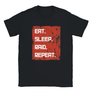 May include: Black t-shirt with a red rectangle graphic that says "Eat. Sleep. Raid. Repeat."