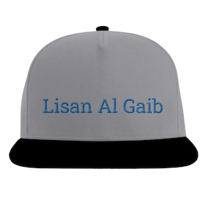 May include: A gray and black baseball cap with the text "Lisan Al Gaib" embroidered in blue on the front.