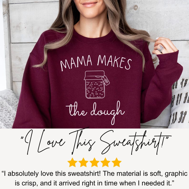 May include: Burgundy sweatshirt with white text that reads "Mama Makes the Dough" and a graphic of a jar with a label that says "Dough".