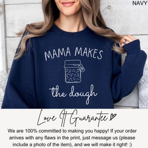 May include: Navy blue sweatshirt with the text "Mama Makes the Dough" and a graphic of a jar with dough rising. The text "Love It Guarantee" is below the graphic.