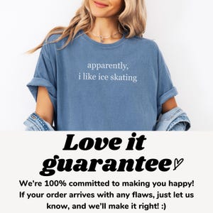 May include: A blue t-shirt with the text "apparently, i like ice skating" in white. The shirt is a solid color and has rolled-up sleeves. The bottom of the image shows the words "Love it guarantee" and a guarantee statement.