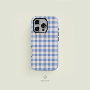May include: A smartphone case with a blue and beige gingham pattern. The case has a camera cutout and black side buttons. The bottom of the case has the text "CASE FACE CASES".