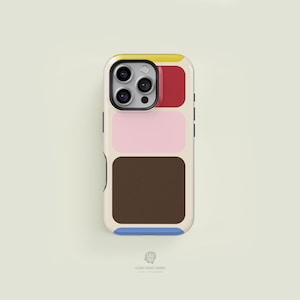 May include: A phone case with a colorful geometric design. The case features a cream-colored background with rectangular blocks of yellow, red, pink, and brown. A blue stripe accents the bottom. The phone's camera is visible at the top.