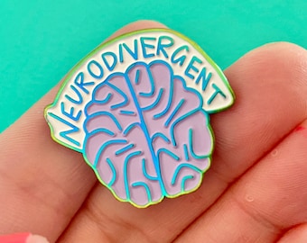 May include: A white enamel pin with a purple brain outline and the text "Neurodivergent" in a blue and green gradient.