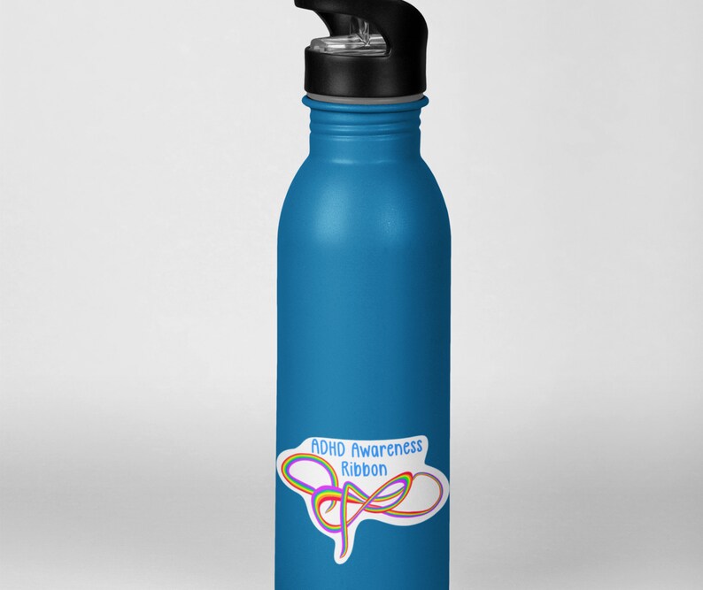May include: A blue reusable water bottle with a black lid and a sticker that says "ADHD Awareness Ribbon" with a rainbow ribbon design.