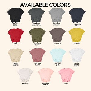 May include: A chart showing 14 different t-shirt colors available for purchase. The colors include solid black, heather dark gray, heather athletic, heather navy, red, heather olive, asphalt, yellow, soft cream, heather mauve, heather ice blue, solid white blend, natural, and heather peach.
