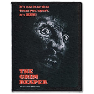 Peut inclure: Écusson rectangulaire noir avec une image en niveaux de gris d'un visage effrayant aux yeux écarquillés. Le texte "It's not fear that tears you apart. It's HIM!" est en haut. En dessous, "THE GRIM REAPER He's coming for you!"