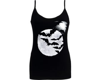 May include: Black camisole top with thin straps. The front features a white graphic of bats flying in front of a full moon. A spooky and stylish top for Halloween or gothic-themed outfits.