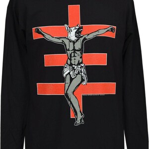Men’s long sleeve t-shirt with bold red cross and crucified dog-headed figure artwork by Val Denham – dark, punk, and unapologetically strange.