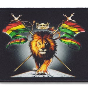 May include: A black patch featuring a lion standing on a white rock, surrounded by two crossed spears with green, yellow and red flags. A gold crown sits above the lion's head.