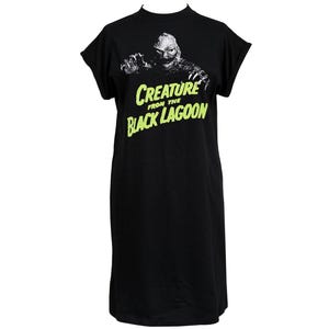 May include: Black t-shirt dress with a graphic of the Creature from the Black Lagoon in white and the text "CREATURE FROM THE BLACK LAGOON" in neon green. The dress has short sleeves and a mock neck.