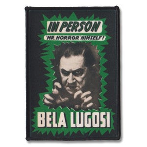 May include: A rectangular embroidered patch featuring a black and white portrait of Bela Lugosi with clawed hands. The design includes green jagged borders and the text IN PERSON, MR. HORROR HIMSELF, and BELA LUGOSI in bold black lettering.