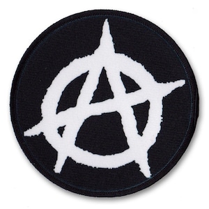 May include: A black and white anarchy symbol patch. The symbol is a circle with a stylised 'A' inside.