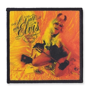 Może przedstawiać: Żółto-pomarańczowa łatka z kobietą w stroju diabła trzymającą gitarę. Tekst "A Date with Elvis" napisany jest stylizowanym fontem.