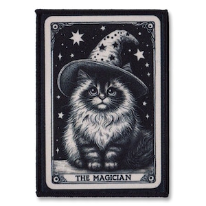 May include: A black and white illustration of a cat wearing a pointed hat with stars in the background. The text "The Magician" is printed below the cat.