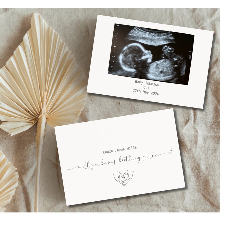 May include: A white card with the text "Baby Johnson due 27th May 2024" and a black and white ultrasound image. A second white card with the text "Laura Jayne Mills will you be my birthing partner?" and a hand drawn heart with two hands.