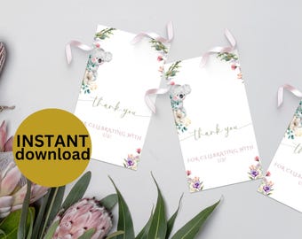 May include: Thank you tags with a floral design and a koala illustration. The text on the tags reads "Thank you for celebrating with us!"