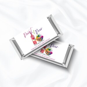 May include: Two silver foil-wrapped chocolate bars with white labels. The labels feature a watercolor painting of a wine bottle, paintbrush, and paint palette. The text on the label reads "Paint & Pour" and "Celebrating Sarah's 30th Birthday".