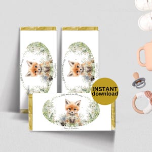 May include: Chocolate bar wrappers with a watercolor fox illustration. The design includes a fox surrounded by flowers, with text that reads "a little one is on the way" and "Fiona & Freddie's". A gold circle with "INSTANT download" is also present.