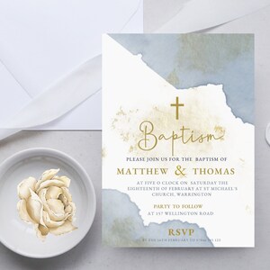 Może przedstawiać: Zaproszenie na chrzest z akwarelowym tłem w odcieniach niebieskiego i złotego. Zaproszenie zawiera krzyż i tekst "Baptism", "Please join us for the baptism of Matthew & Thomas", "At five o'clock on Saturday the eighteenth of February at St Michael's Church, Warrington", "Party to follow at 157 Wellington Road", oraz "RSVP by the 18th February to 01234 567 123".