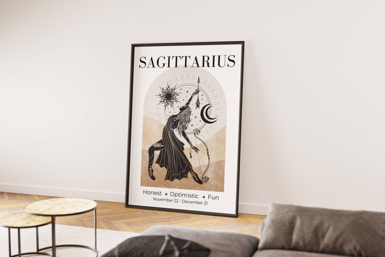 May include: A framed Sagittarius zodiac art print. The artwork features a black and beige illustration of a figure with a bow and arrow, with the word "SAGITTARIUS" at the top. The print also includes the words "Honest + Optimistic + Fun" and the dates November 22 - December 21.