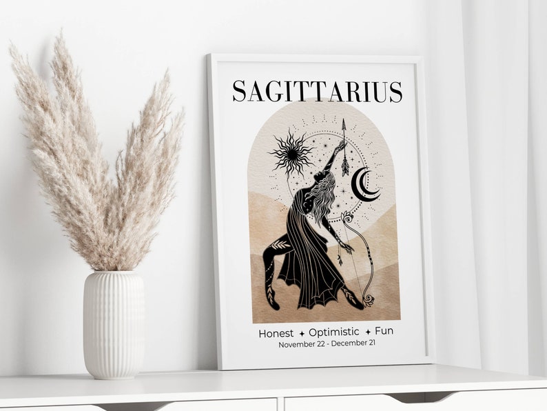 May include: A framed Sagittarius zodiac art print. The black and beige illustration features a woman with a bow and arrow, a sun, and a crescent moon. Text includes "Sagittarius", "Honest + Optimistic + Fun", and the dates November 22 - December 21.